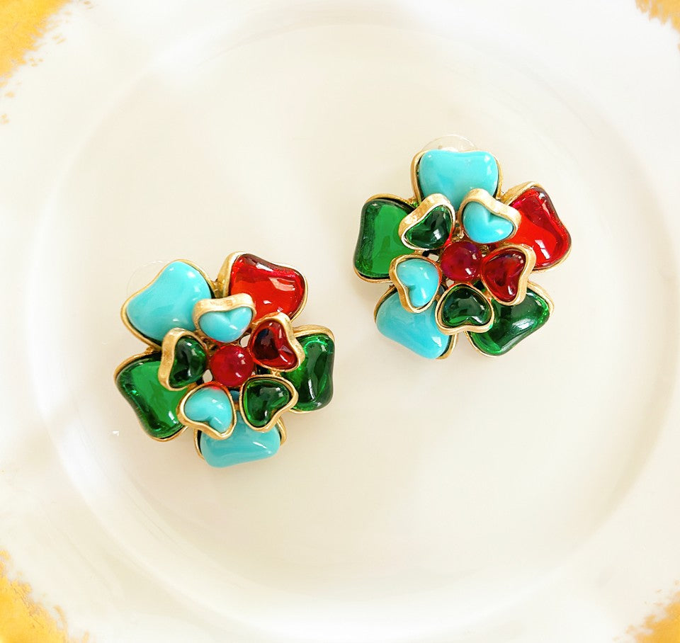 Pair of larger pierced statement flower design earrings.