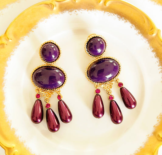 Large statement pierced style earrings.