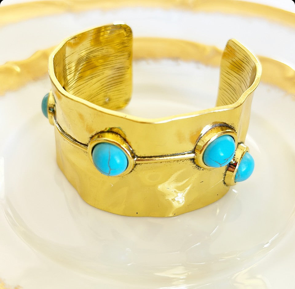 Chunky gold cuff statement bracelet.